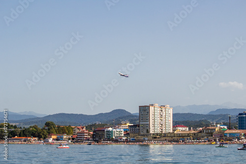 The plane takes off over the mountain view from the sea