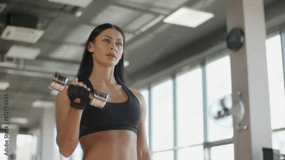 Attractive woman training with barbell in the gym portrait sport hand Attractive woman training with barbell in the gym portrait sport hand