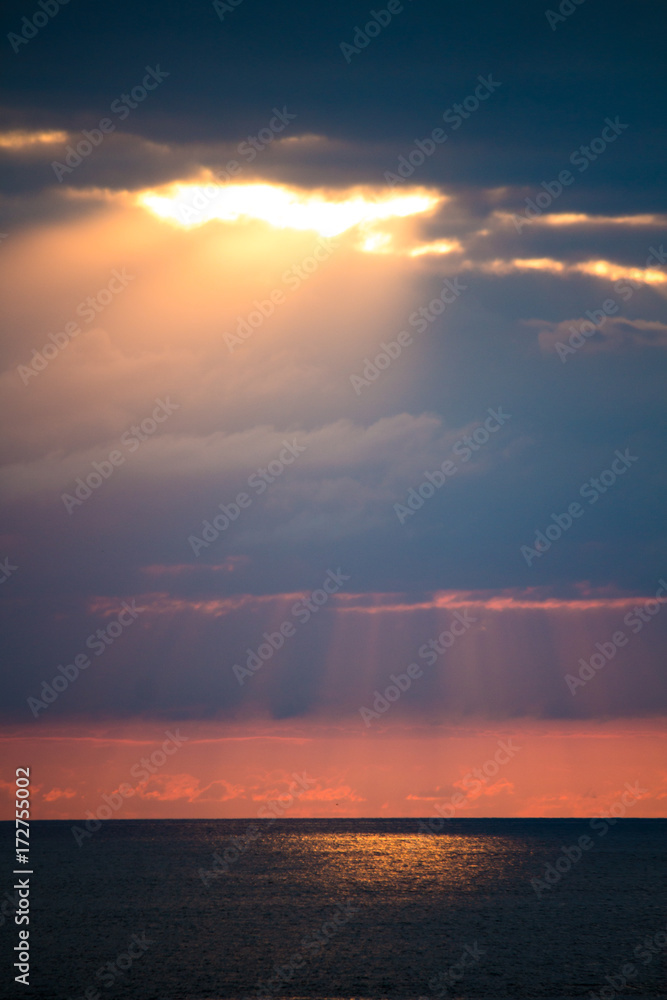 Rays of sun through the clouds over the sea