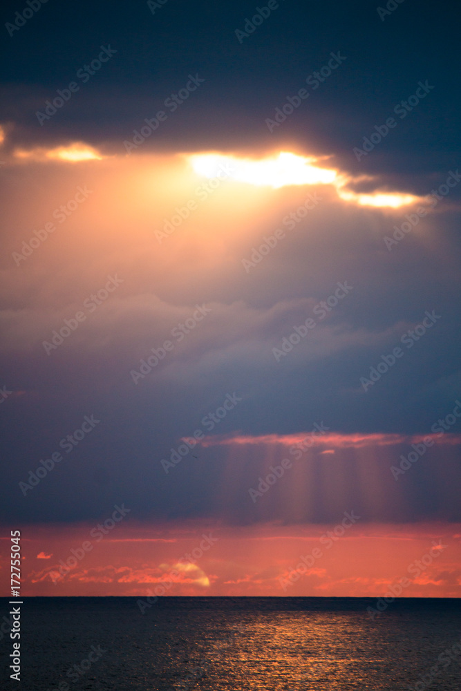Rays of sun through the clouds over the sea Rays of sun through the clouds over the sea