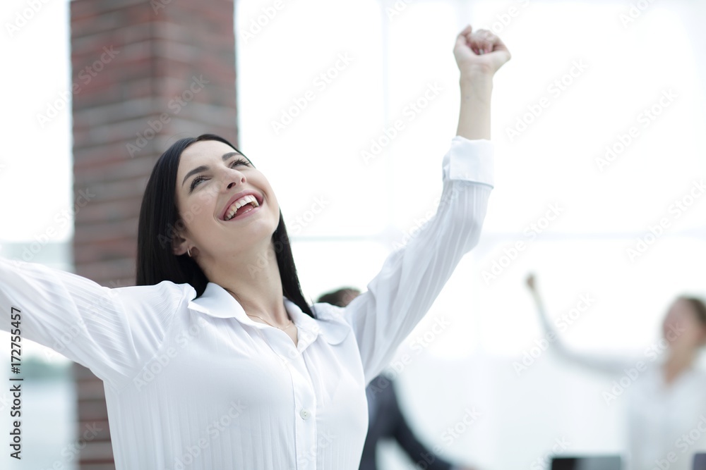 happy young business woman on a blurred office background.