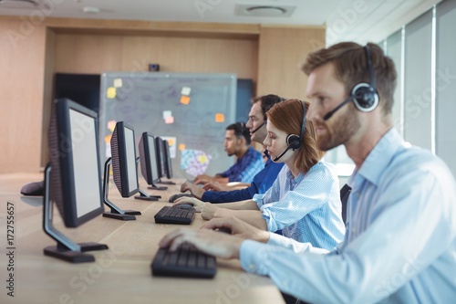 Side view of business people working at call center © wavebreak3