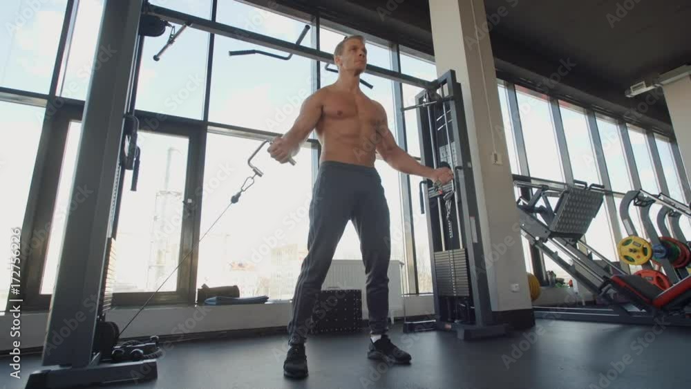 Muscle man training hands in the gym simulator sport ab slide Muscle man training hands in the gym simulator sport ab slide