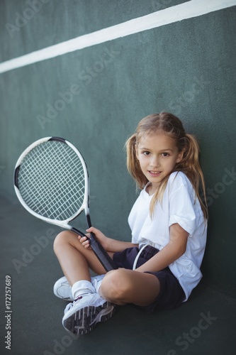 Portrait of girl holding tennis racket  © wavebreak3