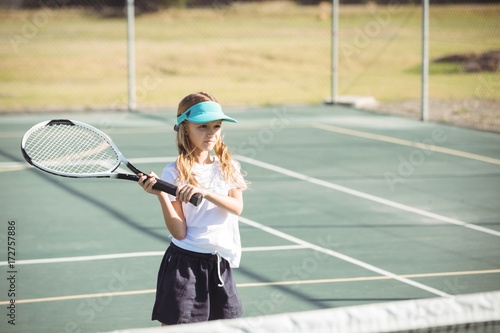 Girl playing tennis on sunny day © wavebreak3