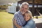 Smiling senior couple embracing each other in garden