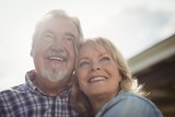 Smiling senior couple standing together in garden