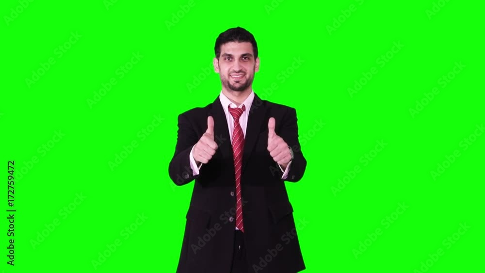 Successful Caucasian businessman wearing formal suit and showing thumbs up in the studio against green screen background Successful Caucasian businessman wearing formal suit and showing thumbs up in the studio against green screen background