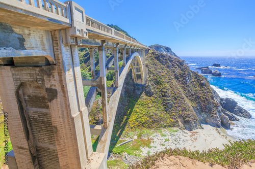 California travel concept. Iconic Bixby Creek Bridge on Pacific Coast Highway 1. Bixby Bridge is located near collapsed Pfeiffer Canyon Bridge in Big Sur.Popular landmark in California, United States.
