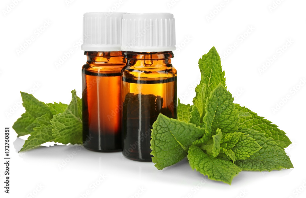 Bottles of essential oil with mint on white background Bottles of essential oil with mint on white background
