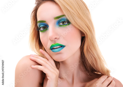 Young woman with bright gre...