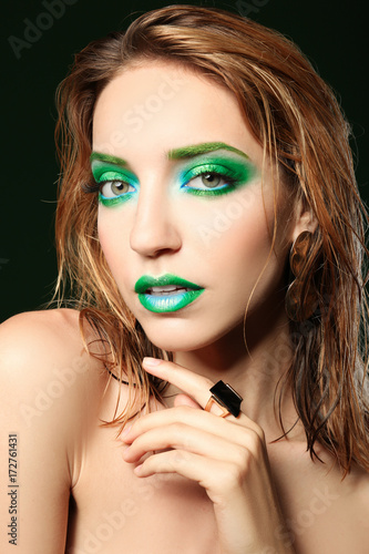 Young woman with bright gre...