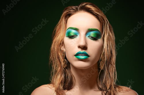Young woman with bright gre...