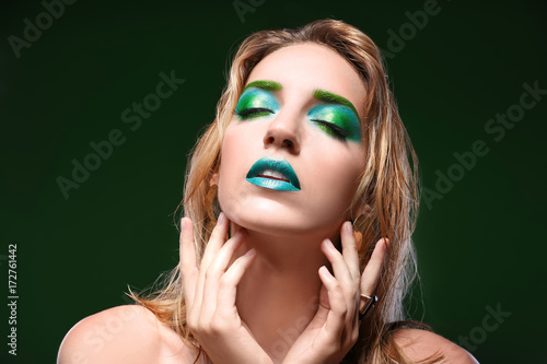 Young woman with bright gre...
