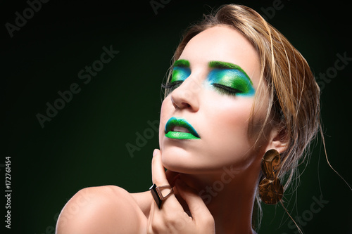 Young woman with bright gre...