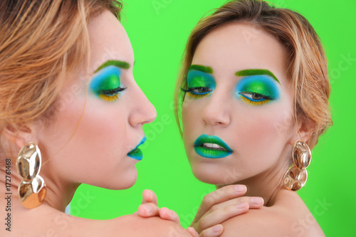 Young woman with bright gre...