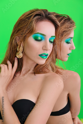 Young woman with bright gre...
