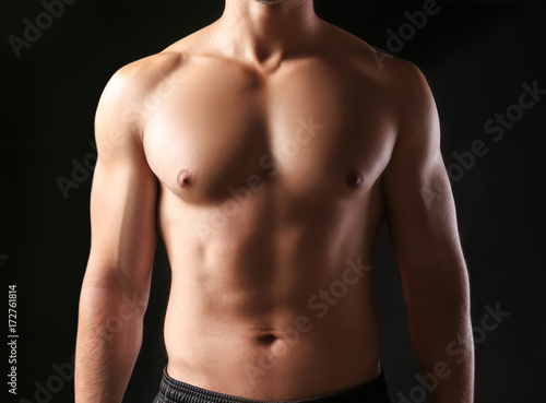 Sporty young man on dark background