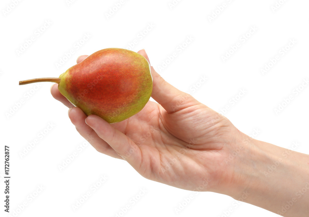 Hand of woman holding delicious ripe pear on white background Hand of woman holding delicious ripe pear on white background
