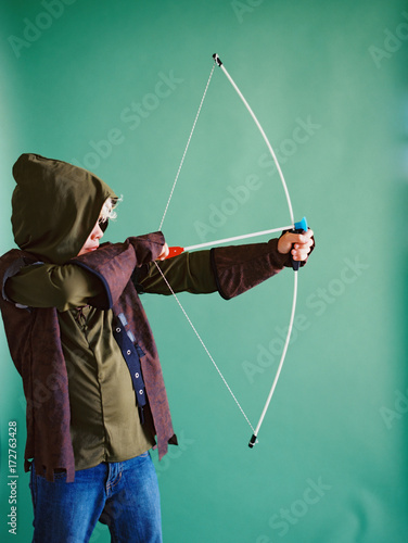 little boy as robin hood costume with bow and arrow