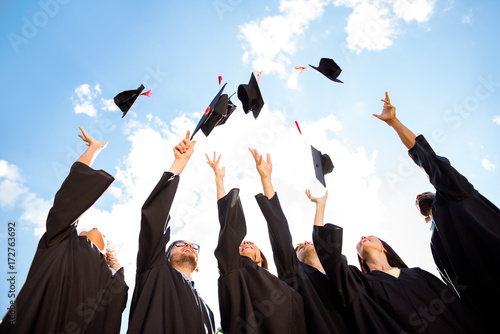 Tableau sur toile Congratulations to graduates! Low angle shot of cheerful group of six young mult