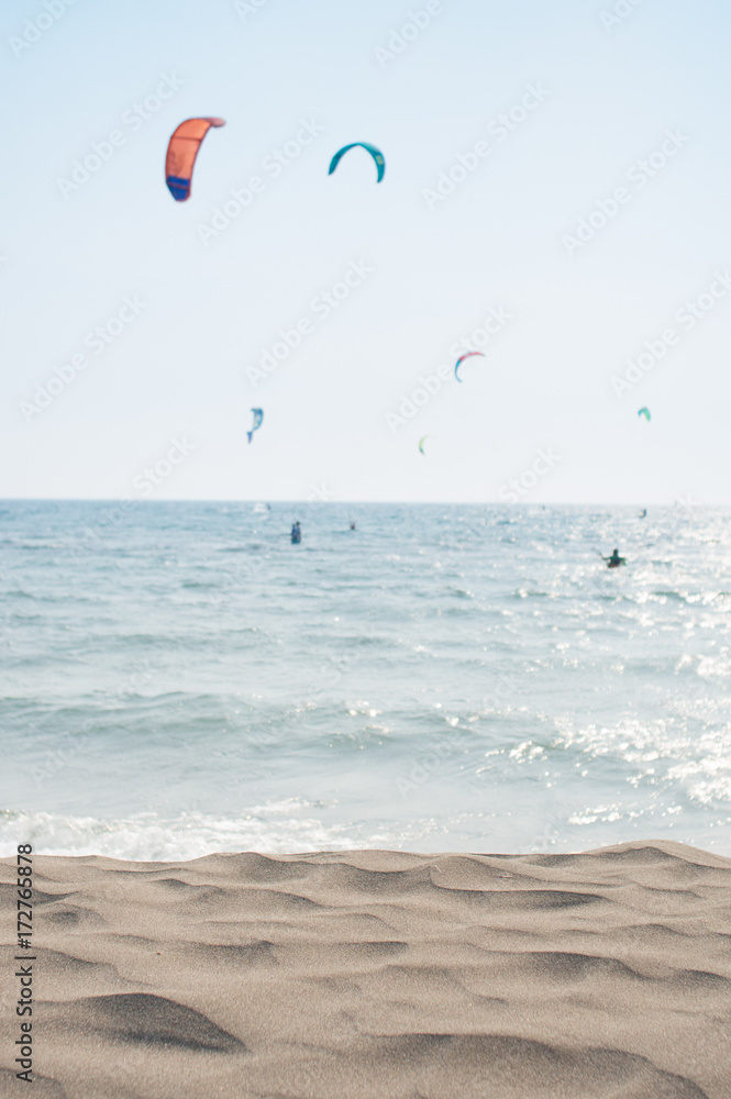 kitesurfing scene with beach sand in front