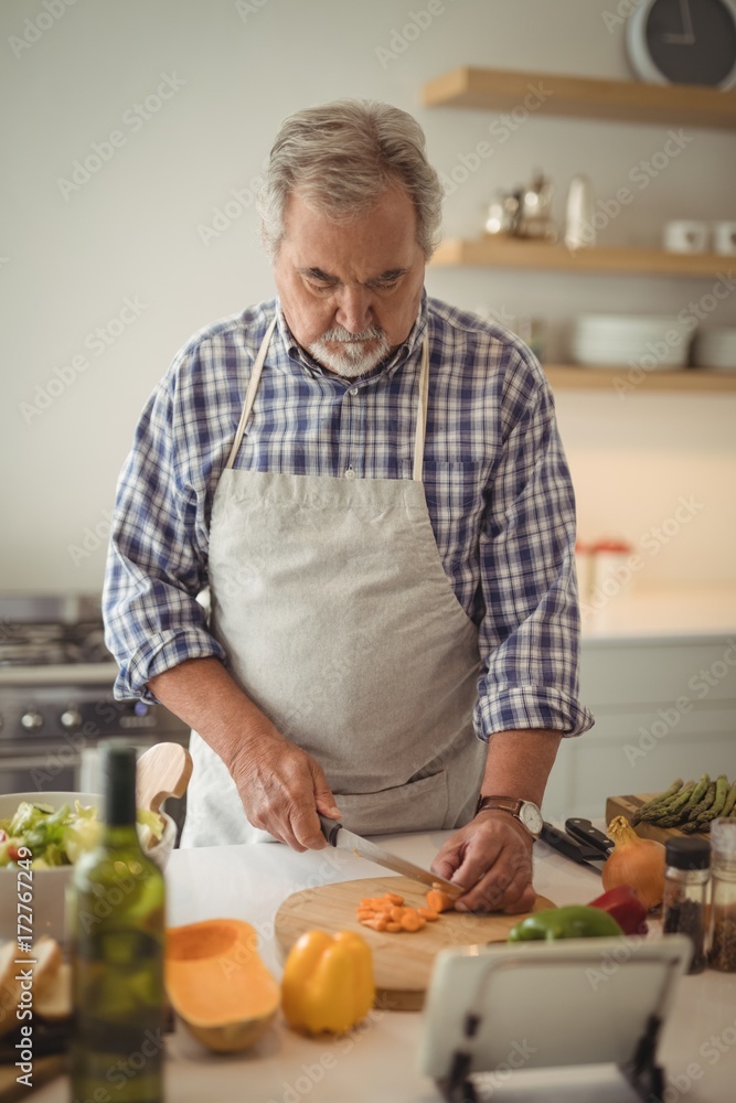 Senior man chopping vegetables Senior man chopping vegetables