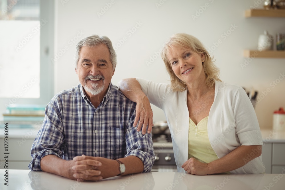 Senior couple sitting in the kitchen Senior couple sitting in the kitchen