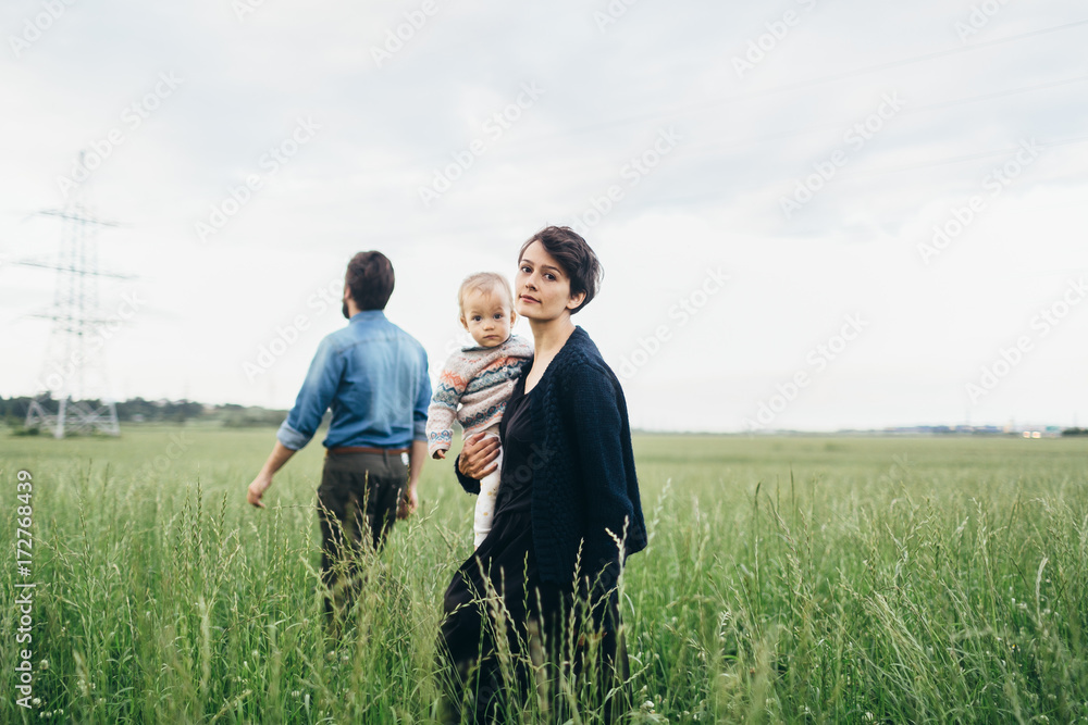 Beautiful family walking through the field Beautiful family walking through the field