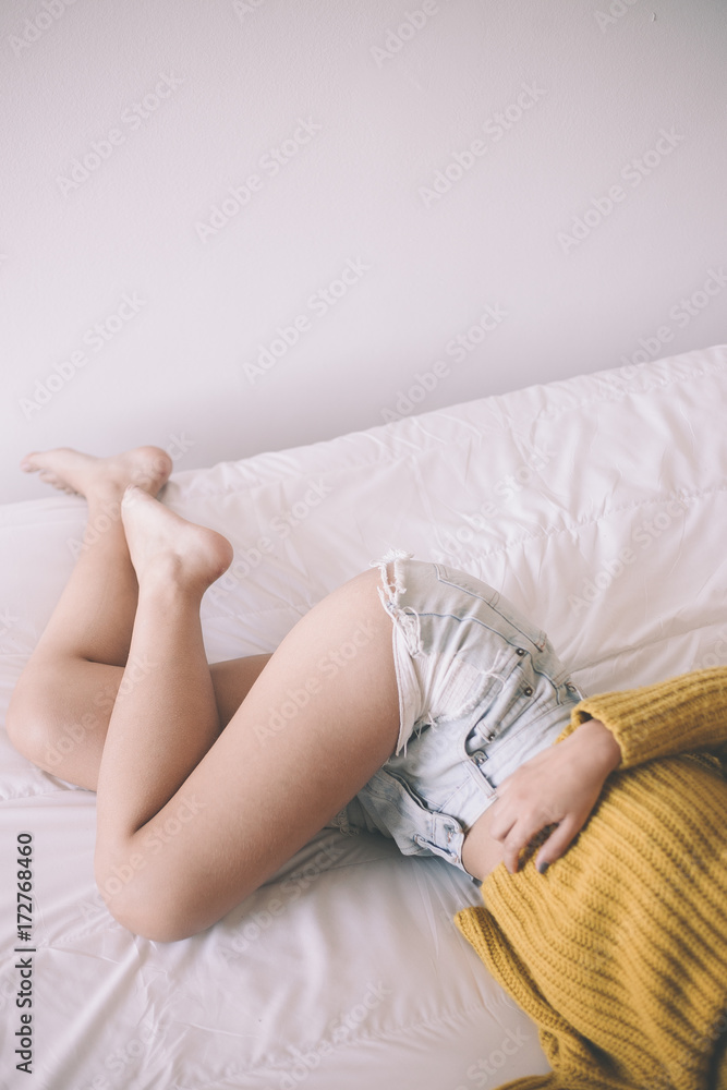 Female legs on a bed Female legs on a bed