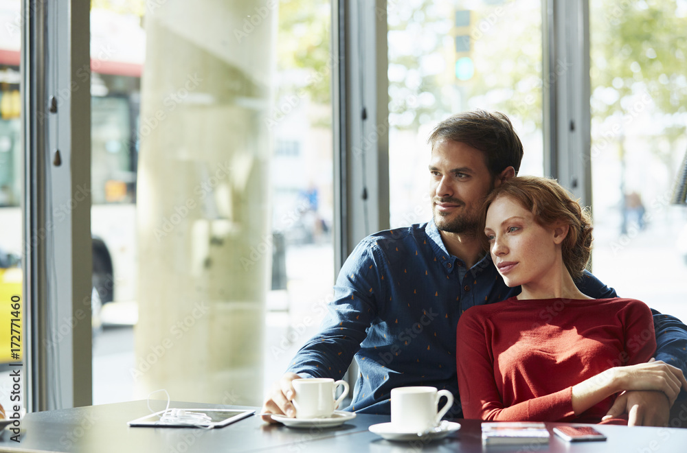 Loving Couple Looking Away While Sitting In Restaurant Loving Couple Looking Away While Sitting In Restaurant