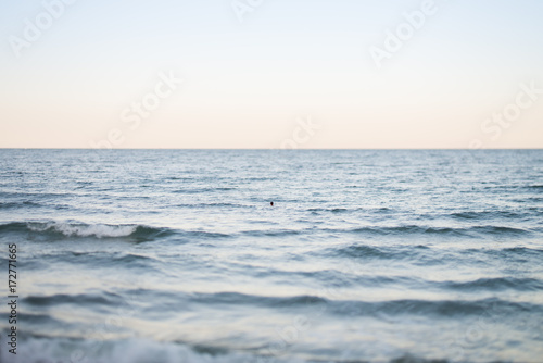 Unrecognizable person swimming in the sea