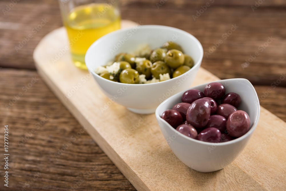 Marinated olives in bowl on chopping board Marinated olives in bowl on chopping board