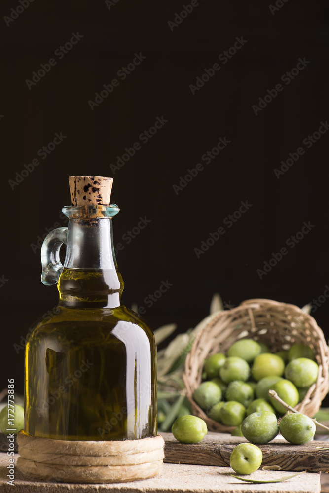 Olive oil and olives on wooden rustic table Olive oil and olives on wooden rustic table