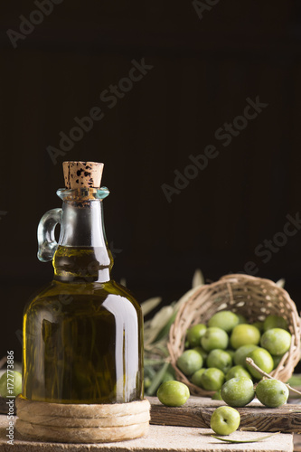 Olive oil and olives on wooden rustic table