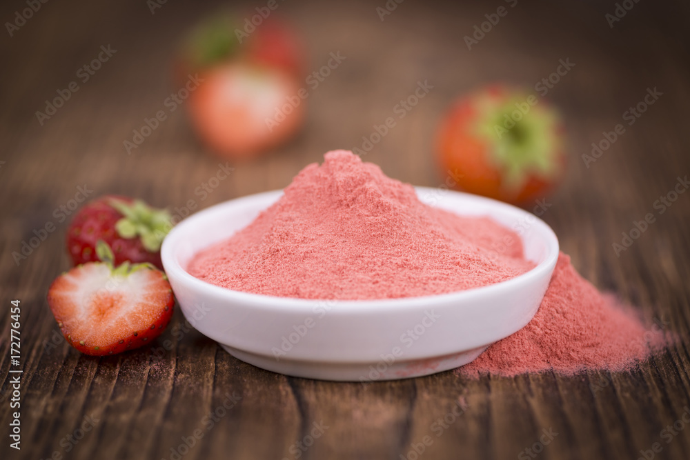 Strawberry powder on wooden background; selective focus Strawberry powder on wooden background; selective focus