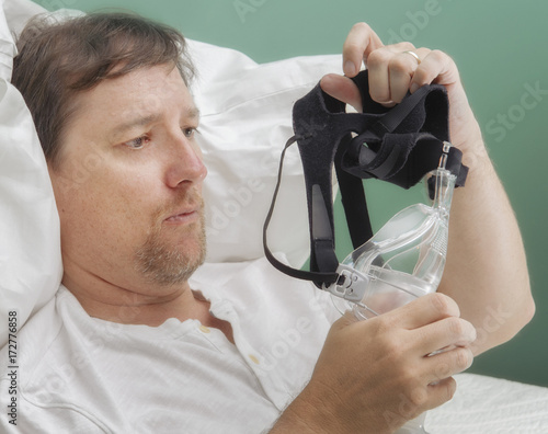 Man examines a BIPAP mask photo