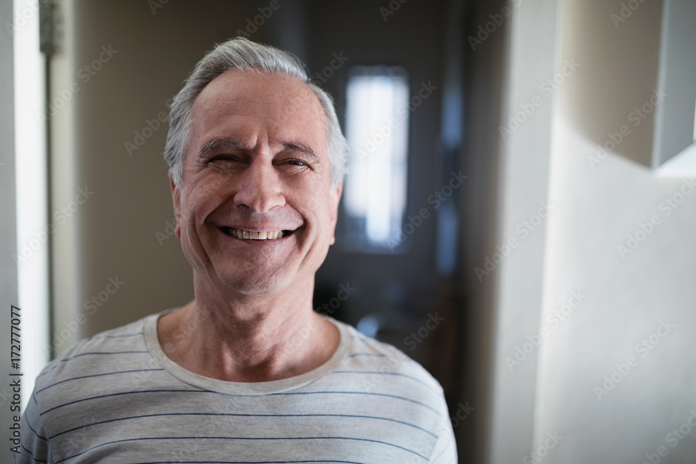 Close-up portrait of smiling senior male patient standing in Close-up portrait of smiling senior male patient standing in