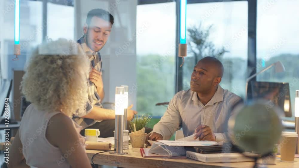 Creative business team brainstorming with sticky notes in modern office ...