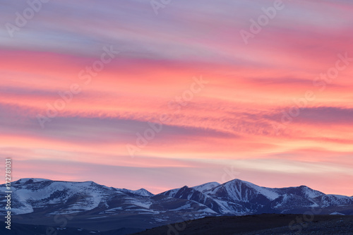 picturesque landscape of snow-covered mountains at sunset
