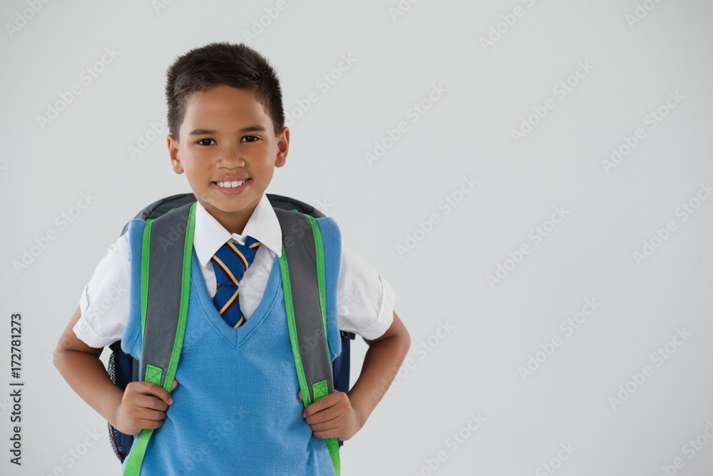 Schoolboy in school uniform with school bag on white background Schoolboy in school uniform with school bag on white background