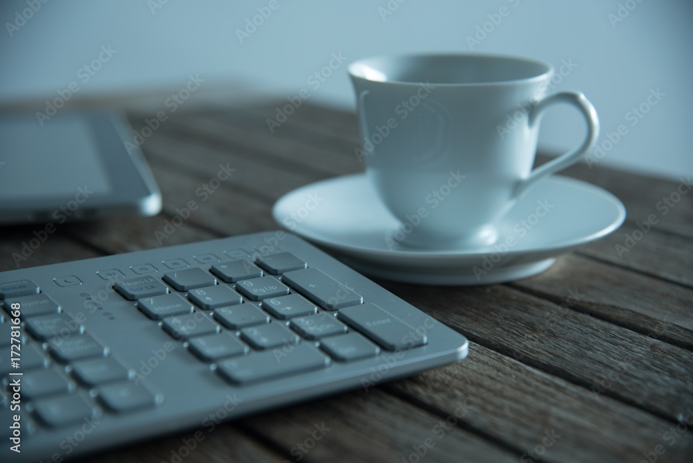 PC keyboard and cup of coffee on old weathering wooden table PC keyboard and cup of coffee on old weathering wooden table