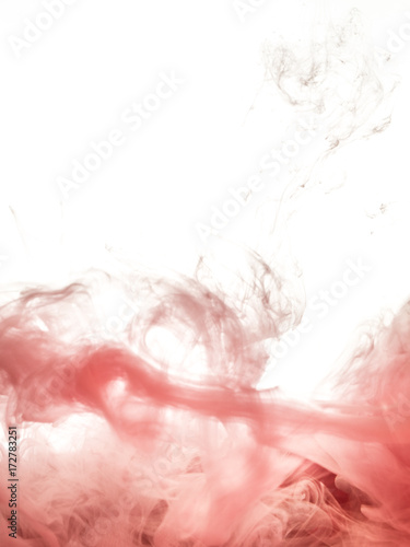 Ink swirl in water isolated on white background. The paint in the water. Soft dissemination a droplets of pink ink in water close-up. Abstract background. Soft focus, blurred backdrop.