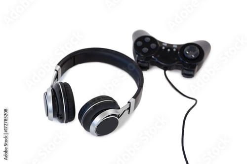 Joystick and headphones on white background
