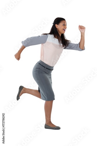 Businesswoman running against white background