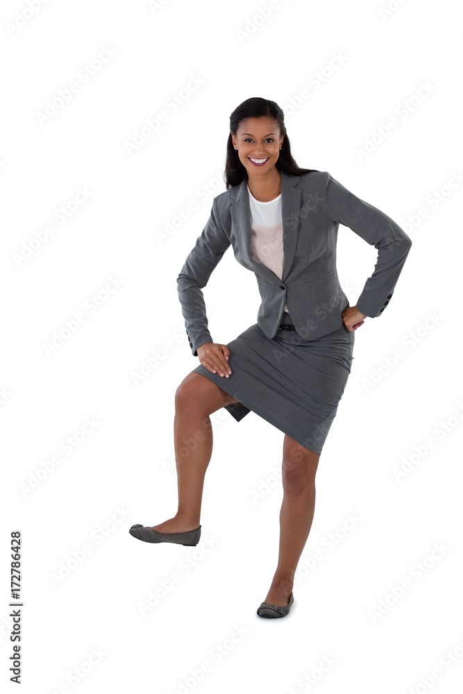 Fototapeta premium Excited businesswoman dancing against white background