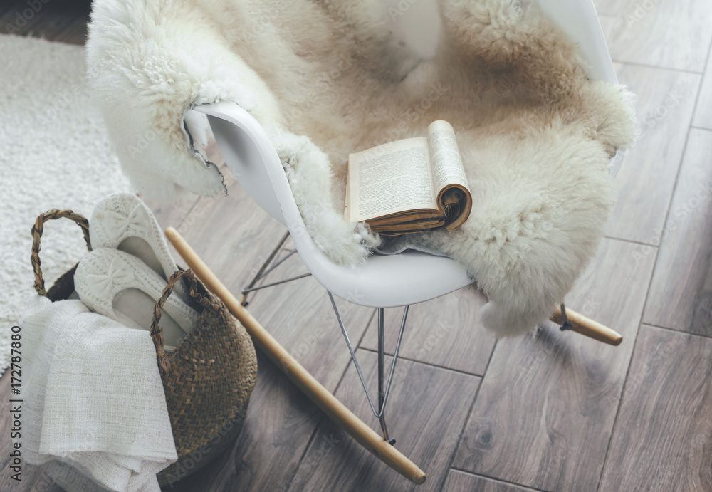 Rocket chair with sheep skin rug in scandinavian living room - obrazy, fototapety, plakaty 