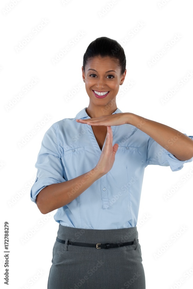 Smiling businesswoman making a timeout hand gesture Smiling businesswoman making a timeout hand gesture