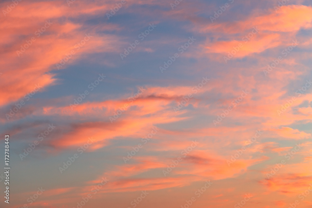 Background created from blue sky at sunset covered with red clouds.