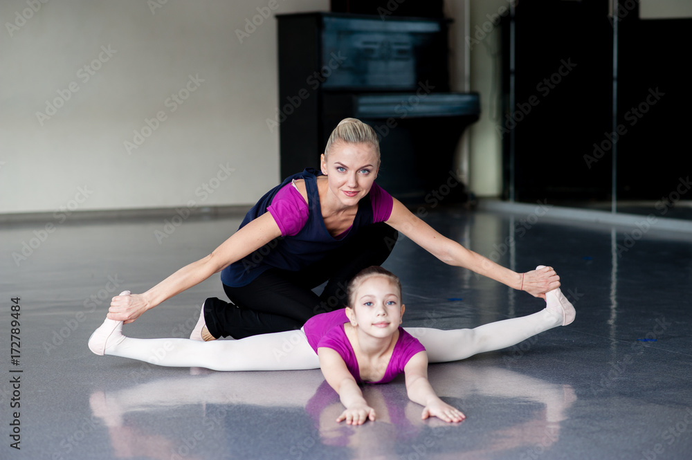 Healthy life education by example - woman and little girl exercising together Healthy life education by example - woman and little girl exercising together
